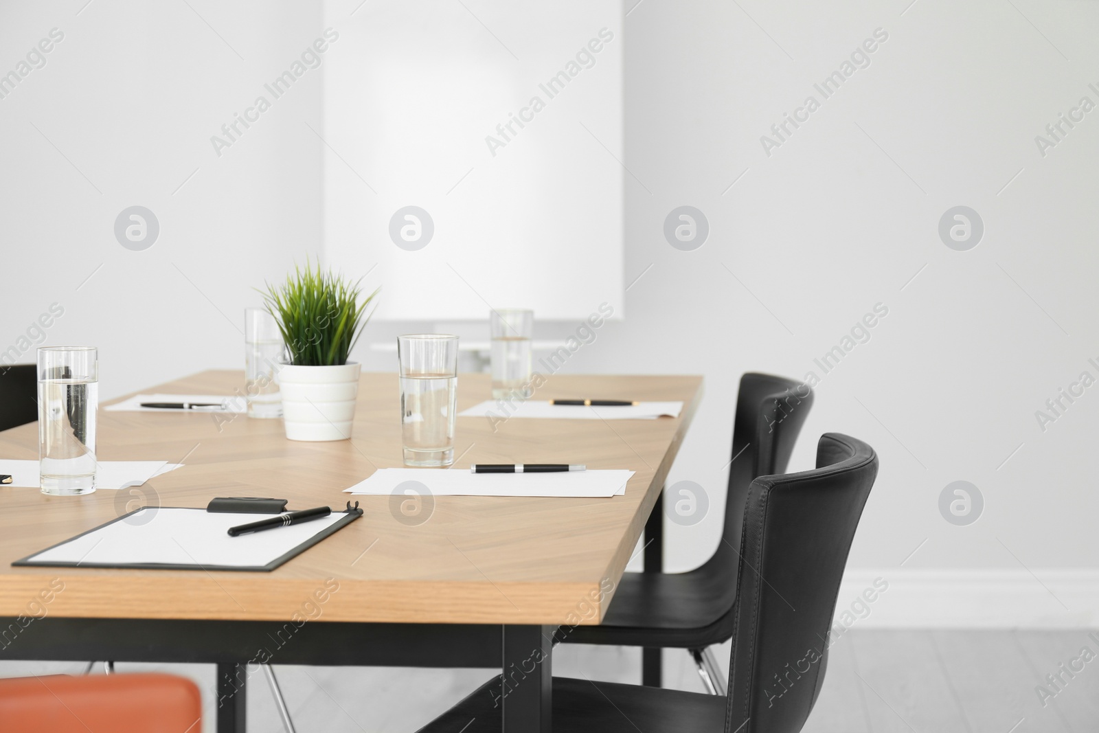 Photo of Simple office interior with large table and chairs