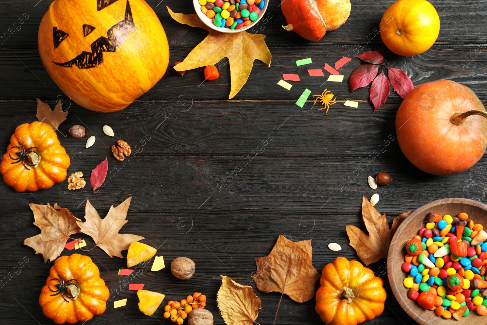 Photo of Halloween pumpkin head jack lantern and holiday decorations on wooden table, flat lay composition with space for text