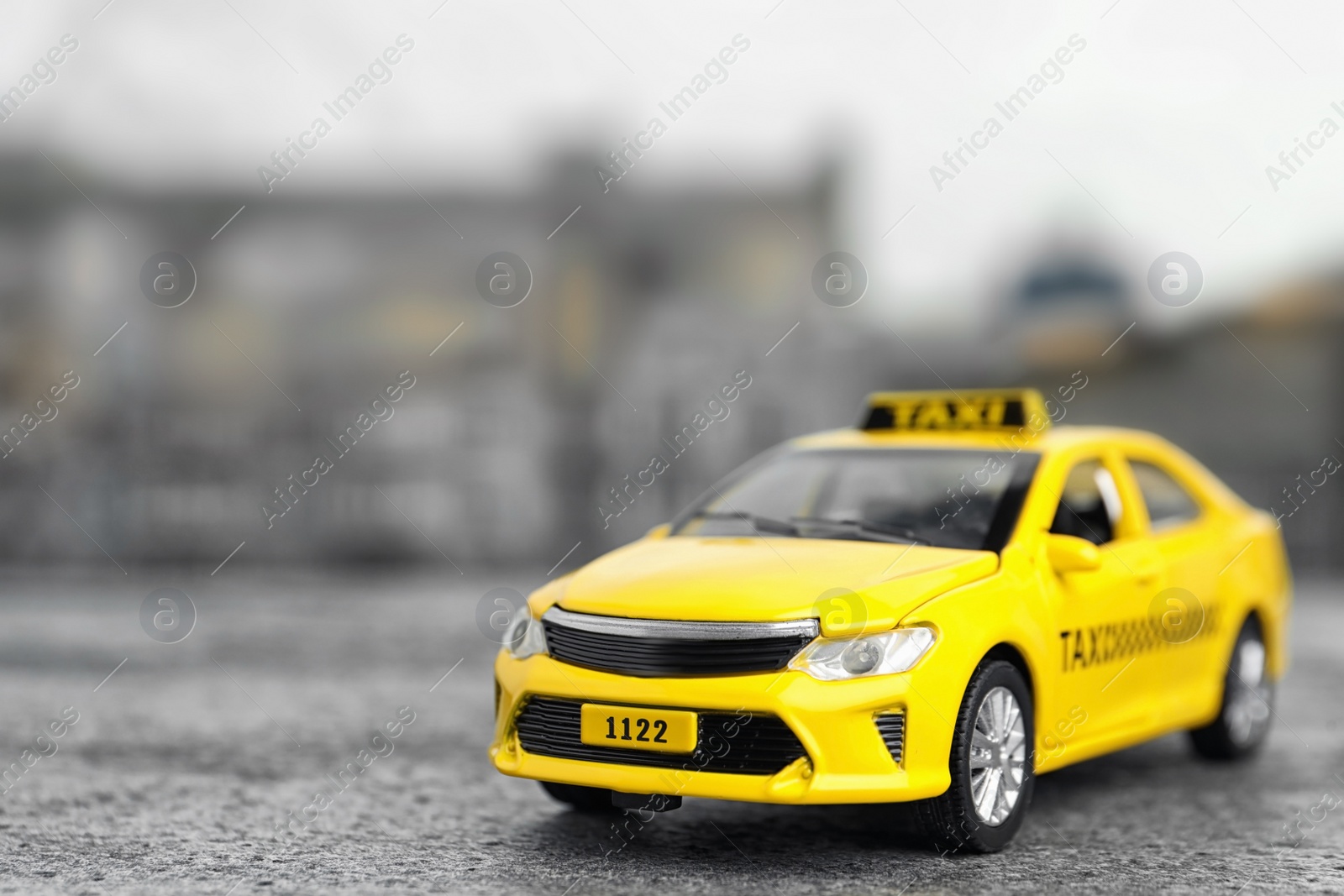 Photo of Yellow taxi car model on city street