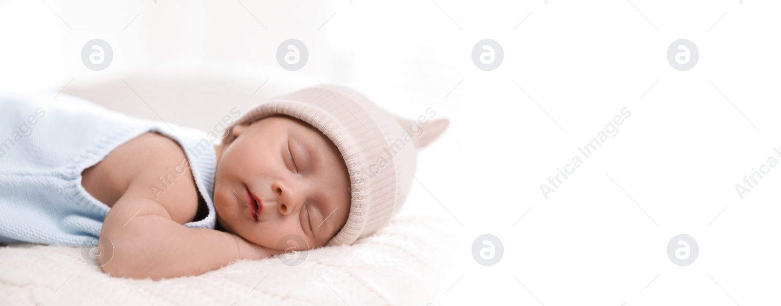 Image of Adorable newborn baby sleeping on white knitted plaid, space for text. Banner design