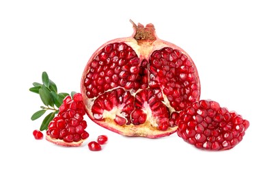 Fresh cut pomegranate and branches isolated on white