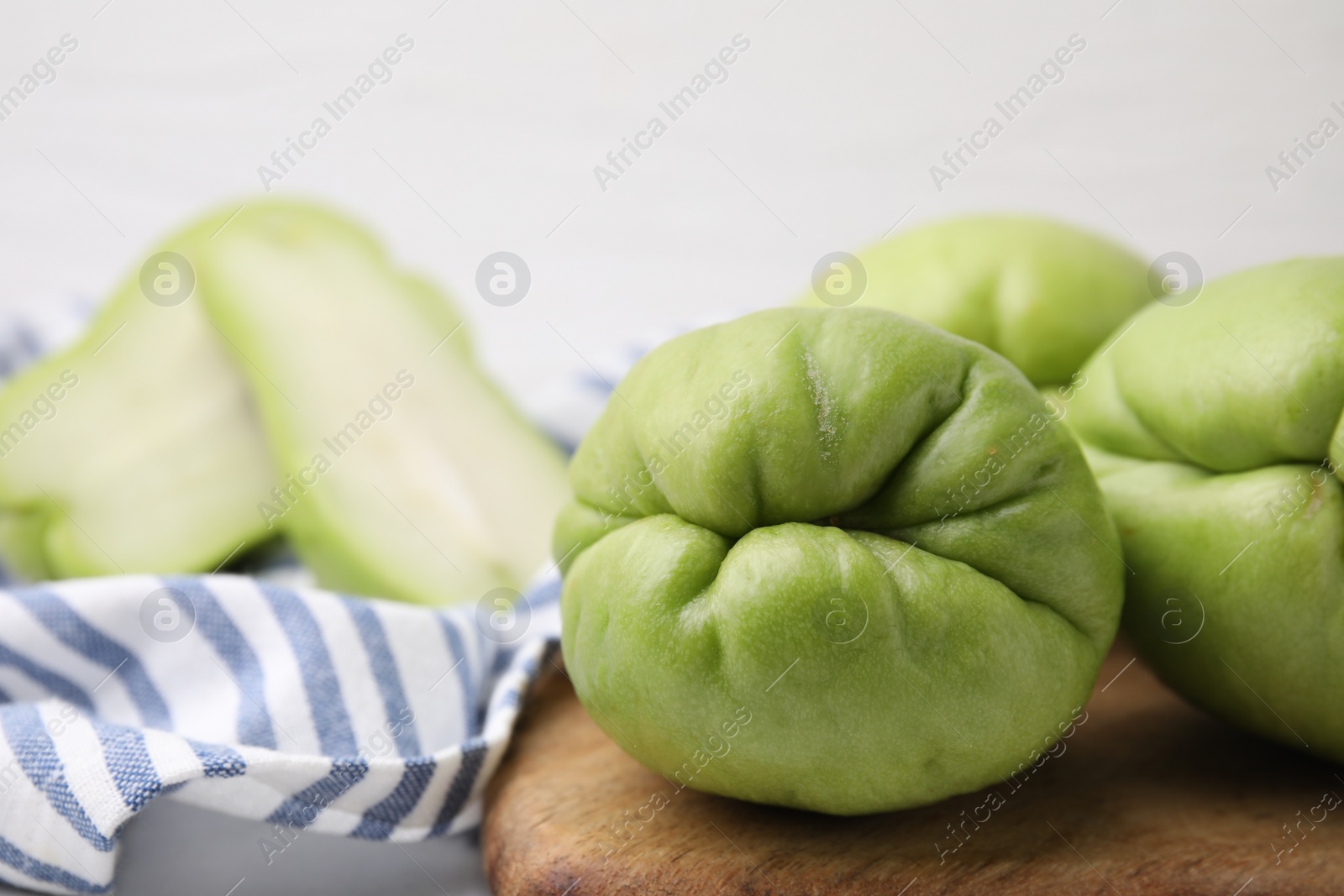 Photo of Many fresh green chayote on table, closeup