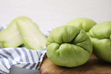 Many fresh green chayote on table, closeup