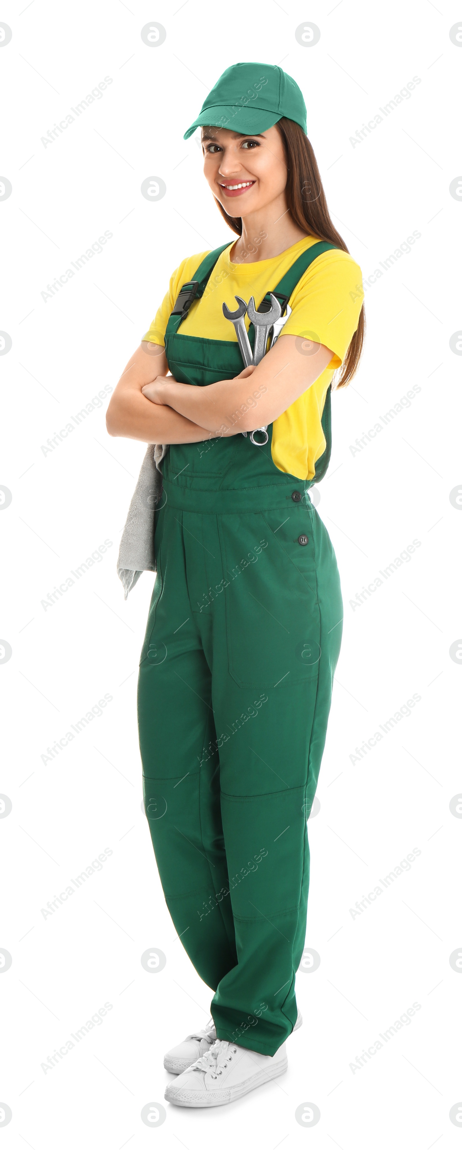 Photo of Full length portrait of professional auto mechanic with wrenches and rag on white background