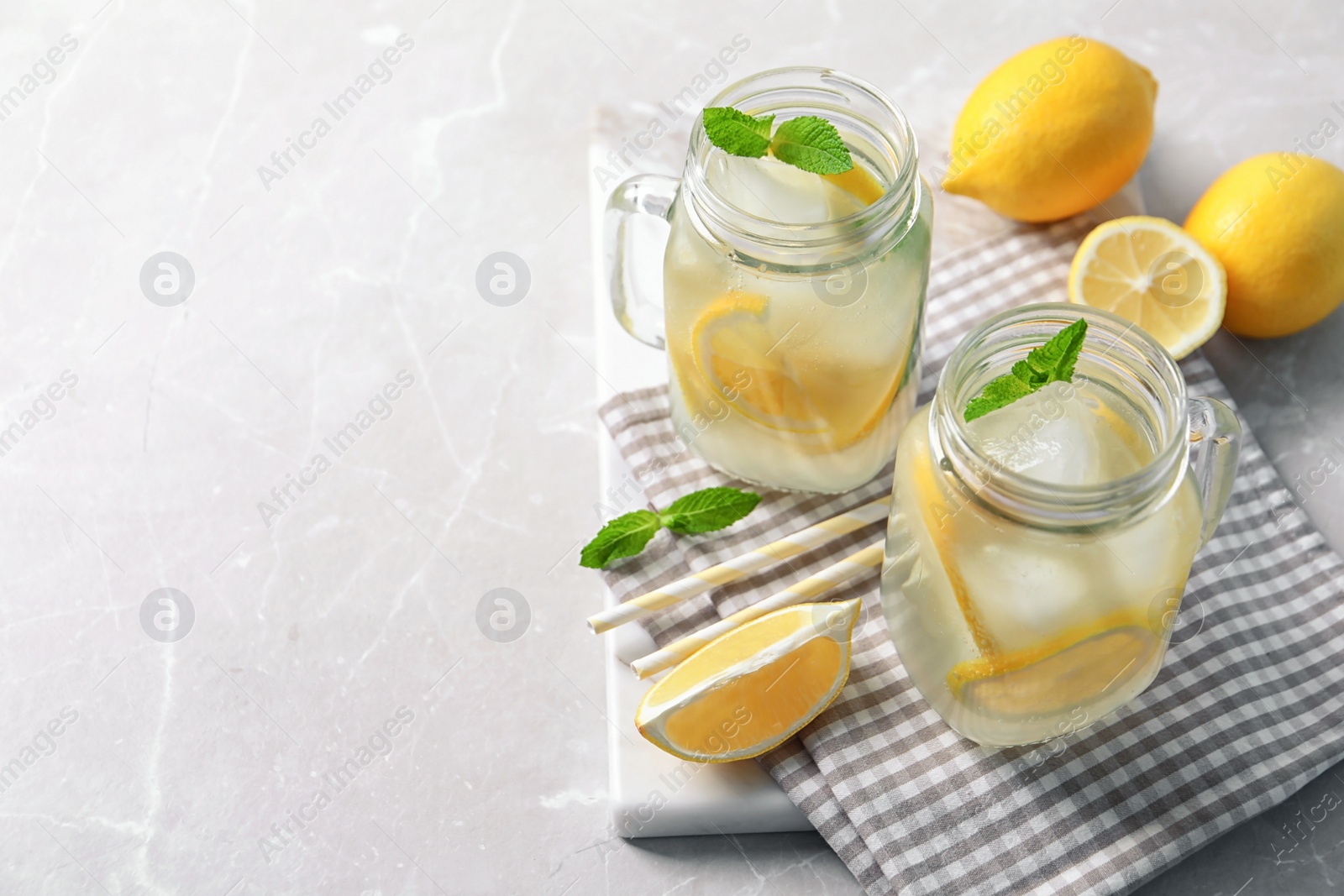 Photo of Mason jars of natural lemonade on table