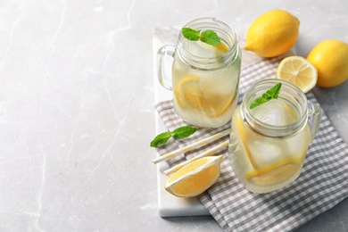 Photo of Mason jars of natural lemonade on table