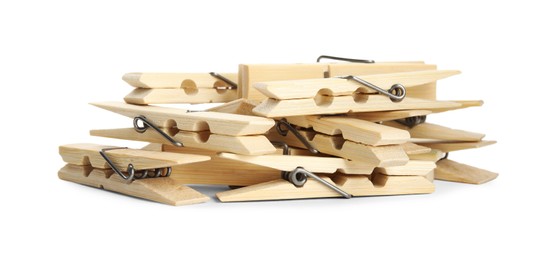 Photo of Pile of wooden clothespins on white background