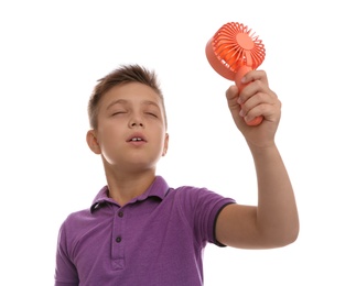 Photo of Little boy enjoying air flow from portable fan on white background. Summer heat