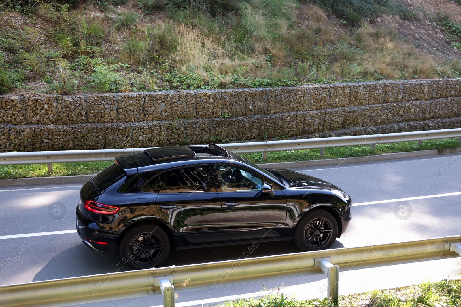 Photo of Picturesque view of asphalt road with modern black car outdoors