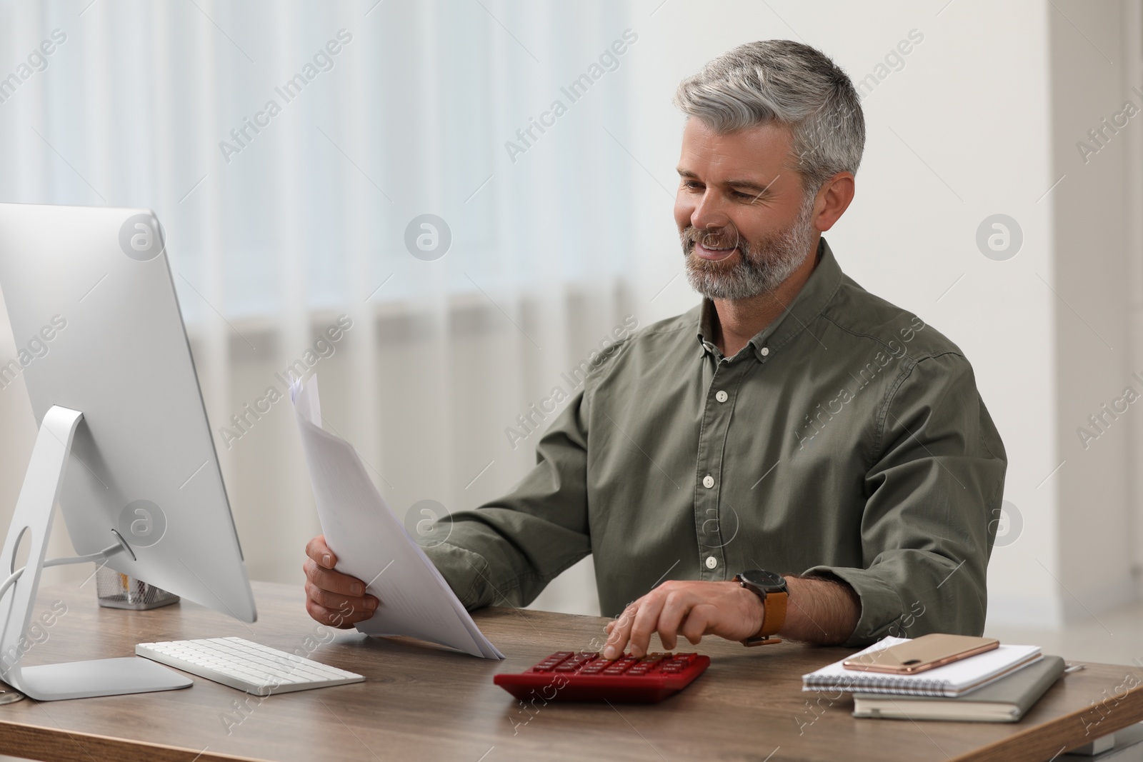 Photo of Professional accountant working at wooden desk in office