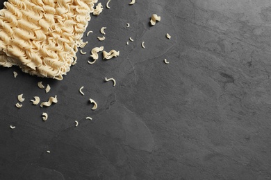 Photo of Block of quick cooking noodles on color background, top view. Space for text