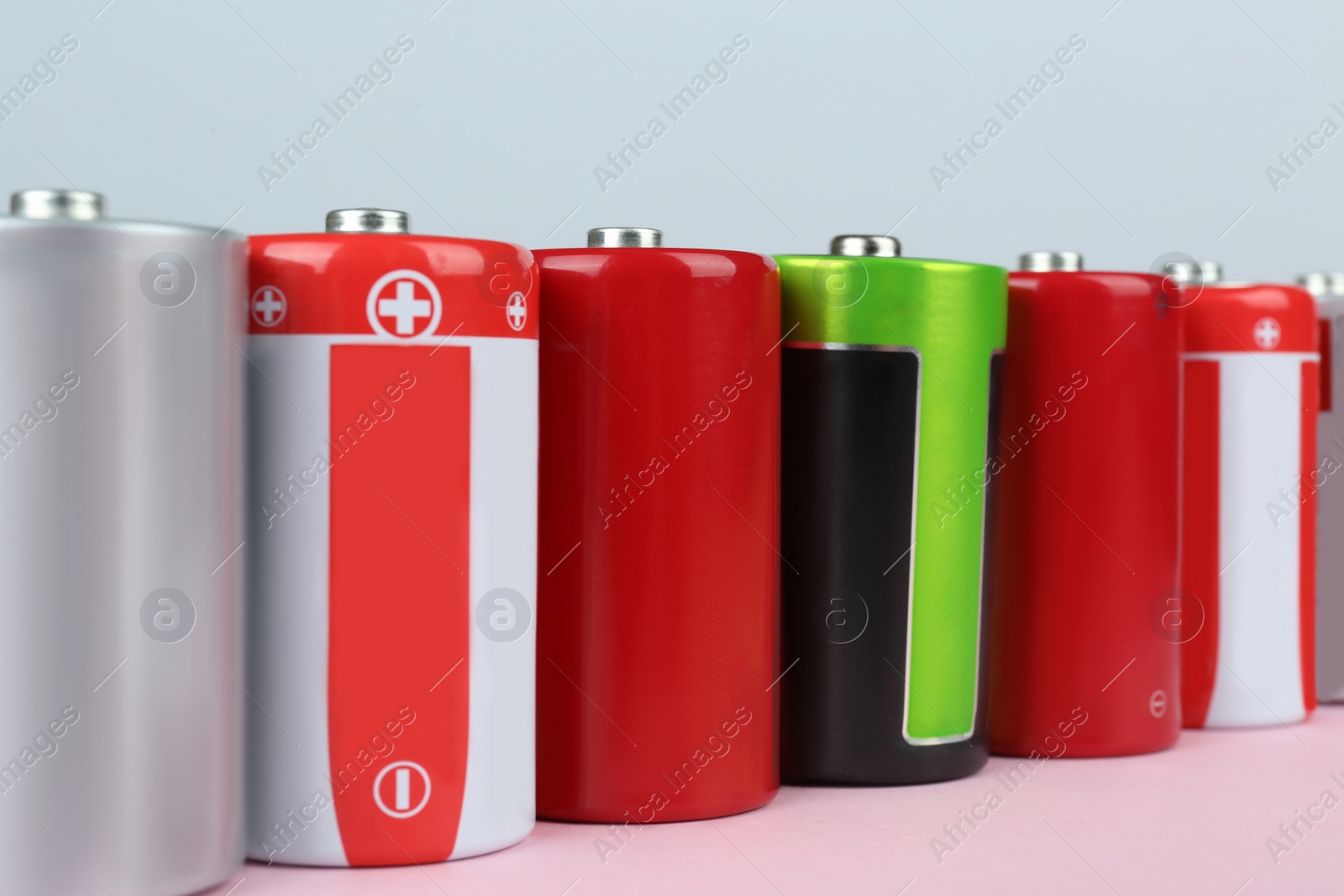 Image of Many new D batteries on color background, closeup
