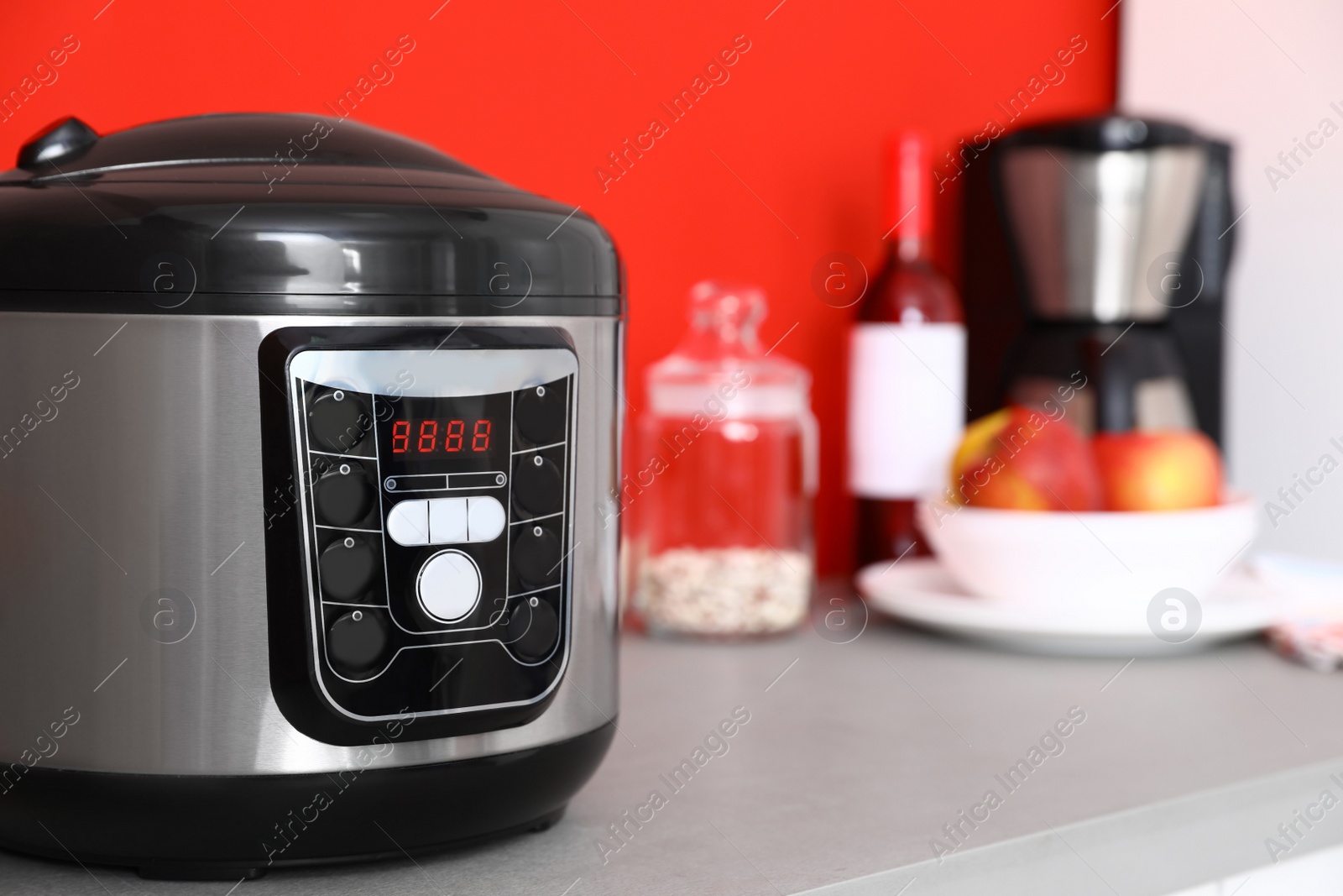Photo of New modern multi cooker on table in kitchen. Space for text
