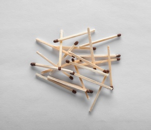 Pile of wooden matches on white background, top view