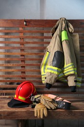 Firefighter`s uniform, helmet, gloves and mask at station
