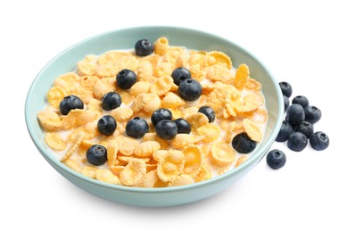 Photo of Bowl of tasty crispy corn flakes with milk and blueberries isolated on white