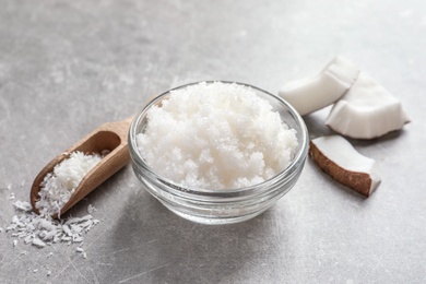 Photo of Glass bowl with natural coconut scrub on table