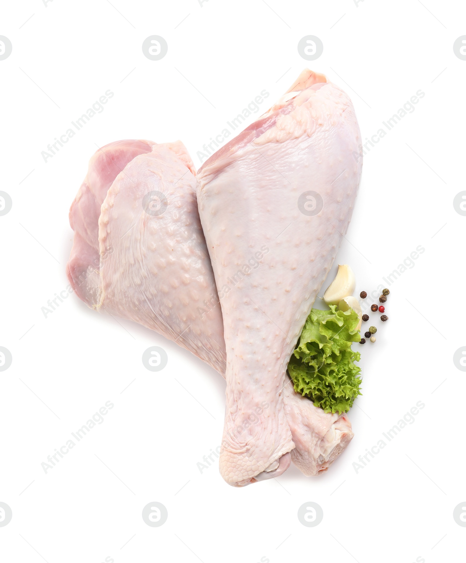 Photo of Raw turkey drumsticks and ingredients on white background, top view
