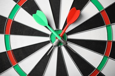 Photo of Red and green arrows on dart board, top view