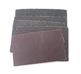 Photo of Many sheets of sandpaper isolated on white, top view