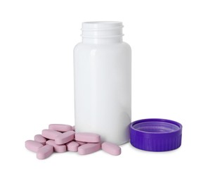 Bottle, lid and pile of vitamin pills isolated on white