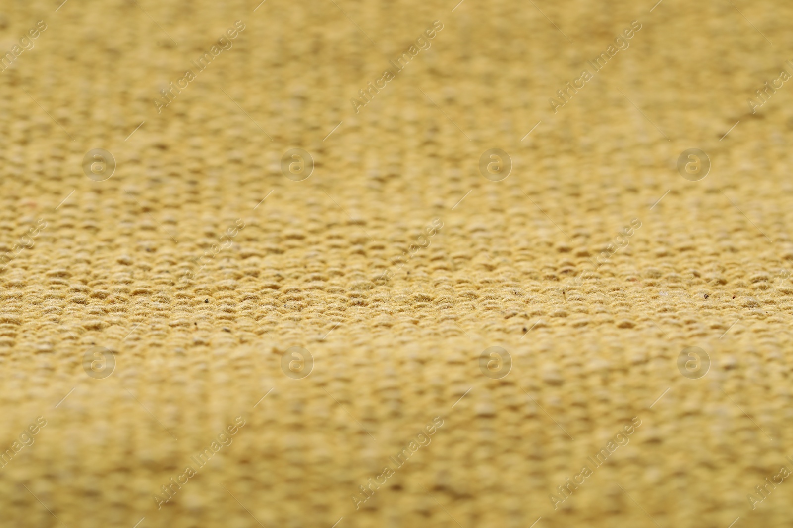 Photo of Texture of soft yellow fabric as background, closeup