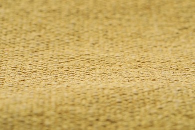 Photo of Texture of soft yellow fabric as background, closeup