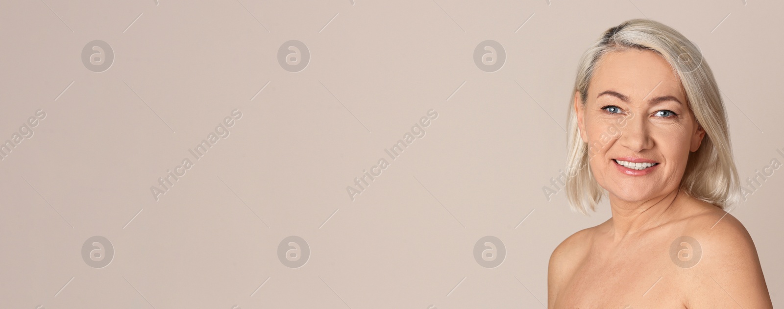 Image of Portrait of beautiful mature woman on beige background, space for text. Banner design