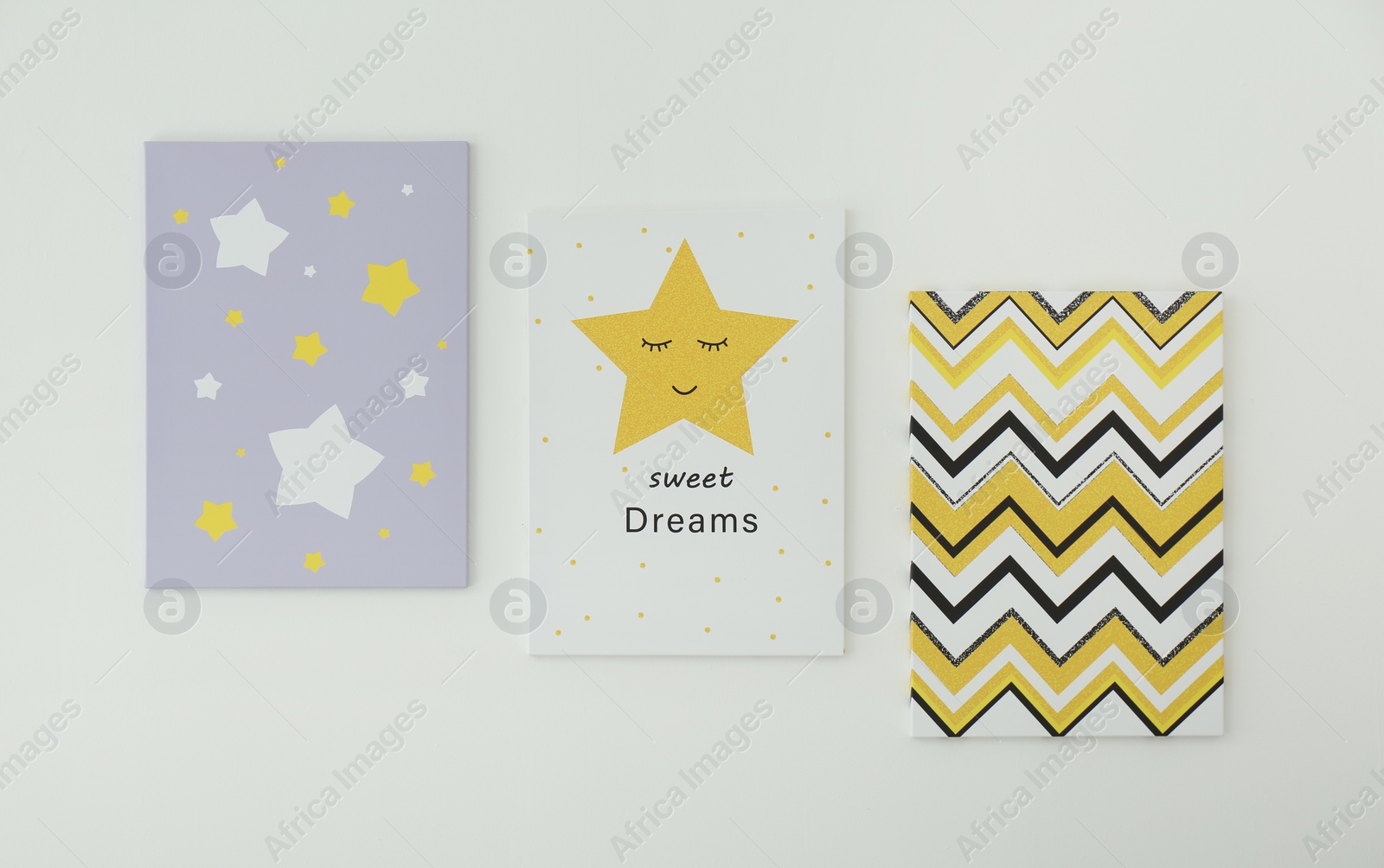 Photo of Different cute pictures on white wall. Children's room interior elements