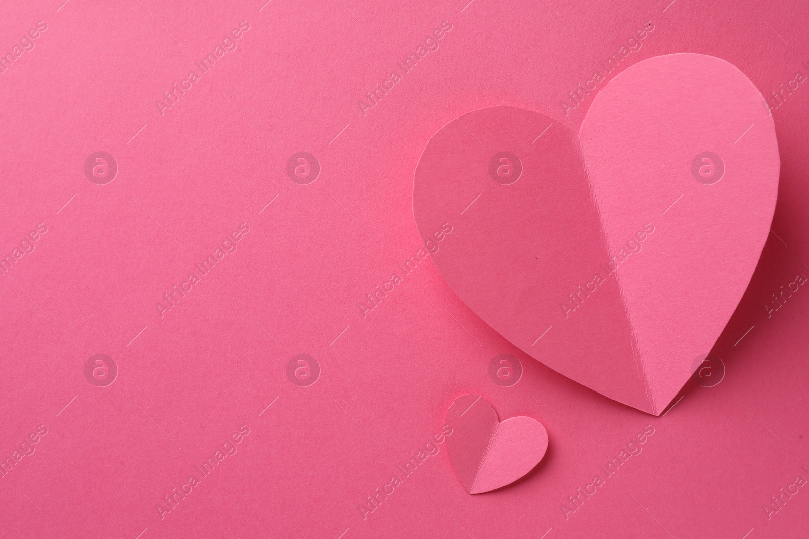 Photo of Paper hearts on pink background, flat lay. Space for text