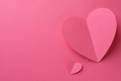 Photo of Paper hearts on pink background, flat lay. Space for text