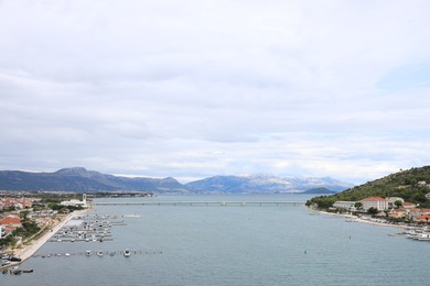 Picturesque view of town, moored boats and sea bay on cloudy day