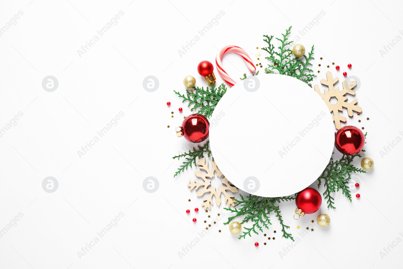 Photo of Flat lay composition with Christmas decor and blank card on white background. Space for text