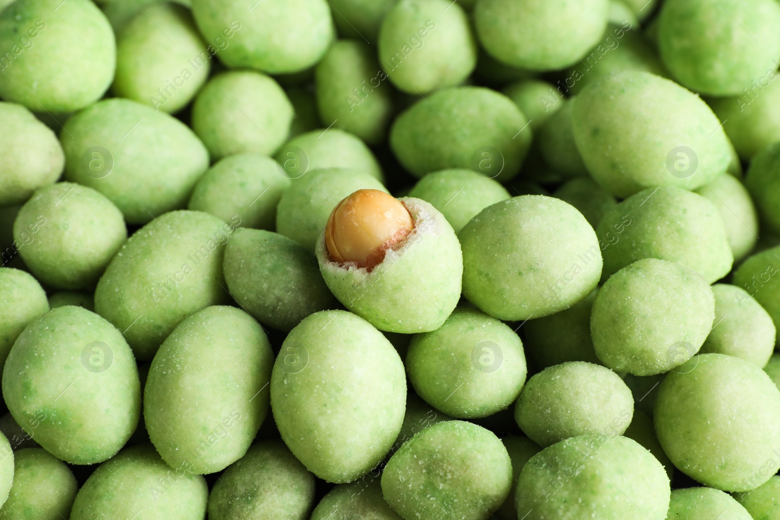 Photo of Tasty wasabi coated peanuts as background, closeup