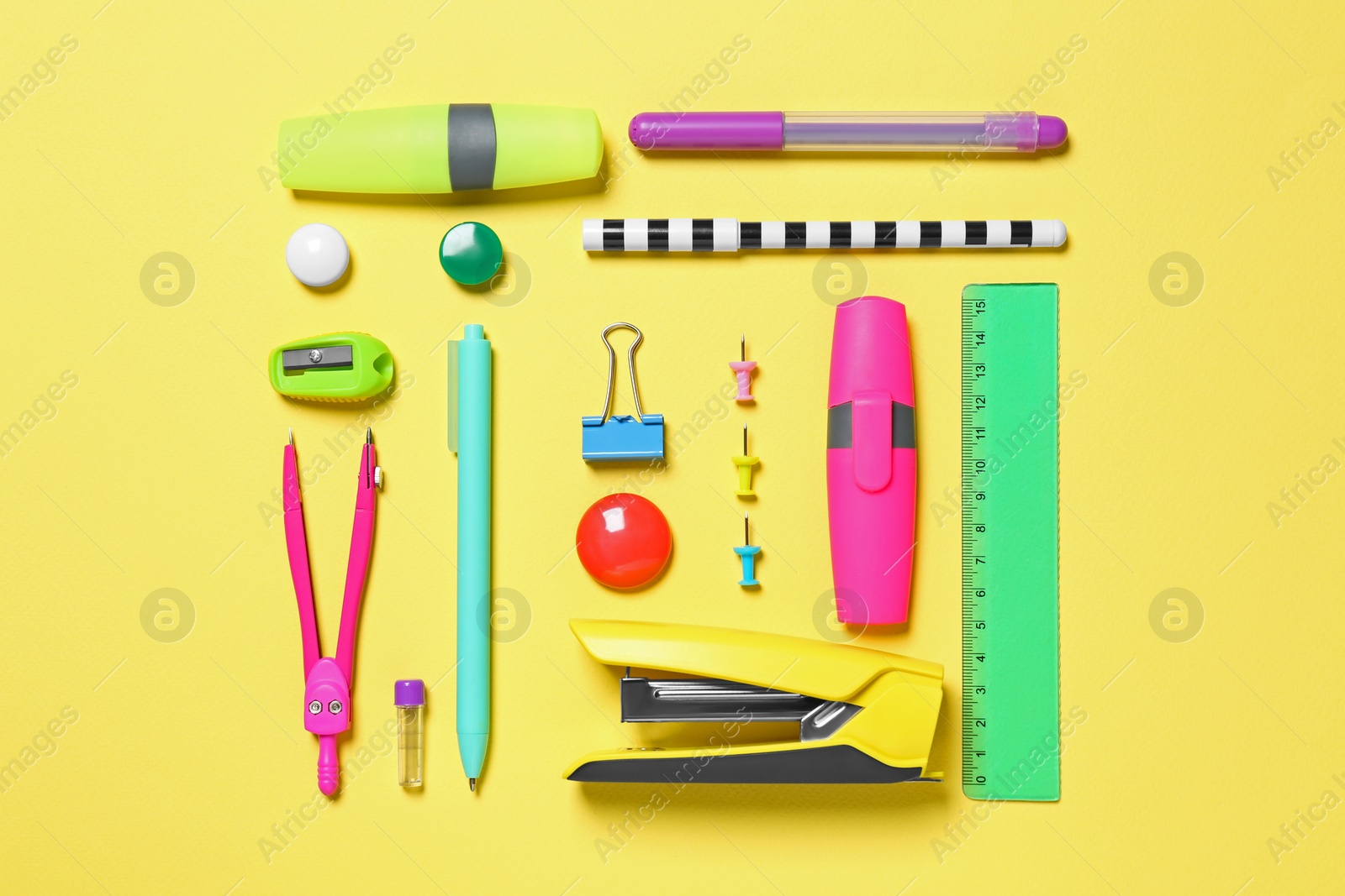 Photo of Flat lay composition with different school stationery on yellow background