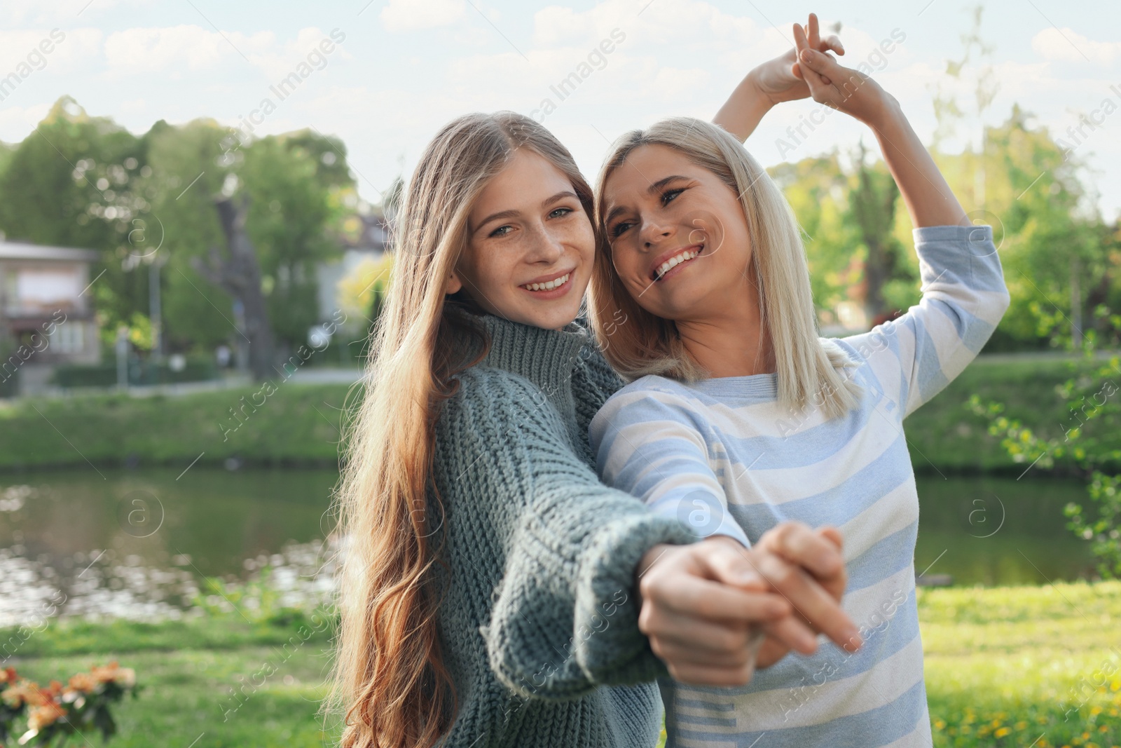 Photo of Happy mother with her daughter spending time together in park on sunny day