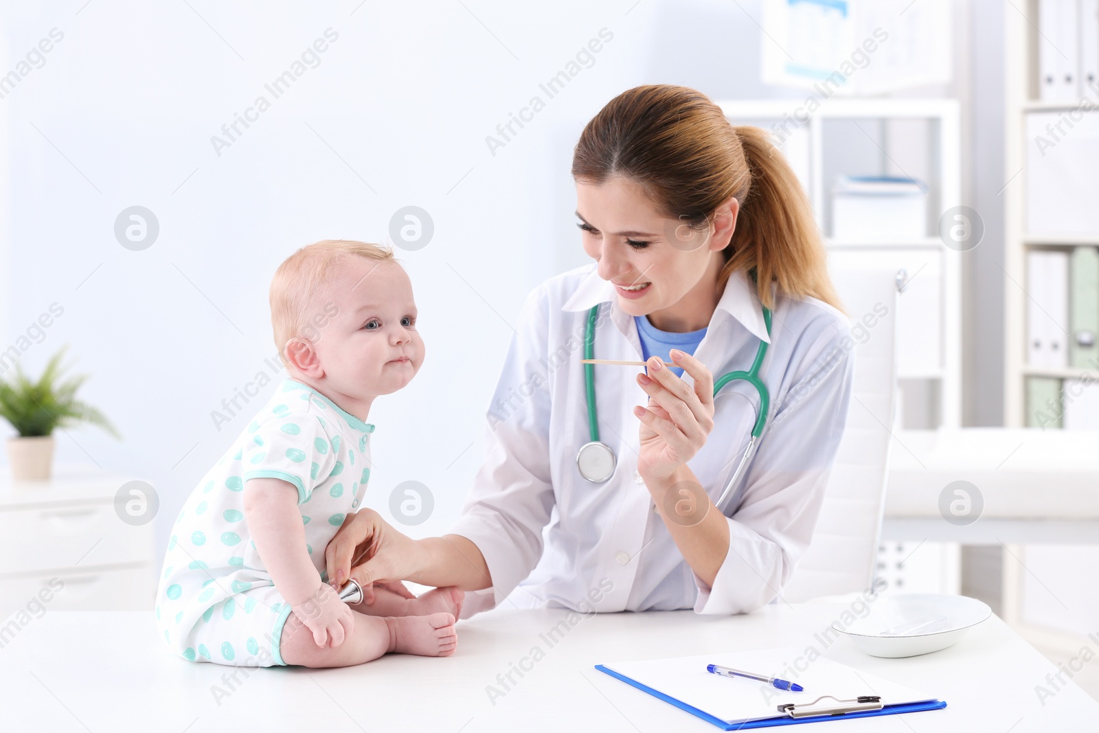 Photo of Children's doctor examining baby's throat in hospital