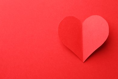 Photo of One paper heart on red background, top view. Space for text