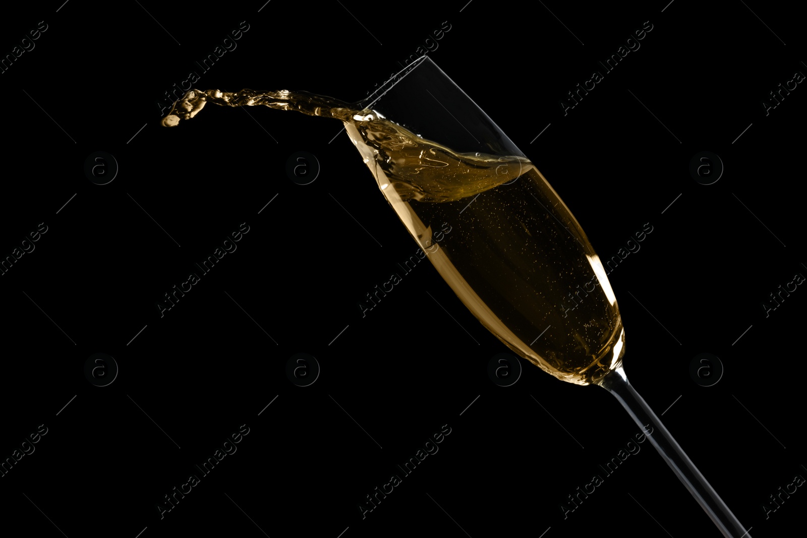 Photo of Glass of fizzy champagne on black background, closeup. Space for text