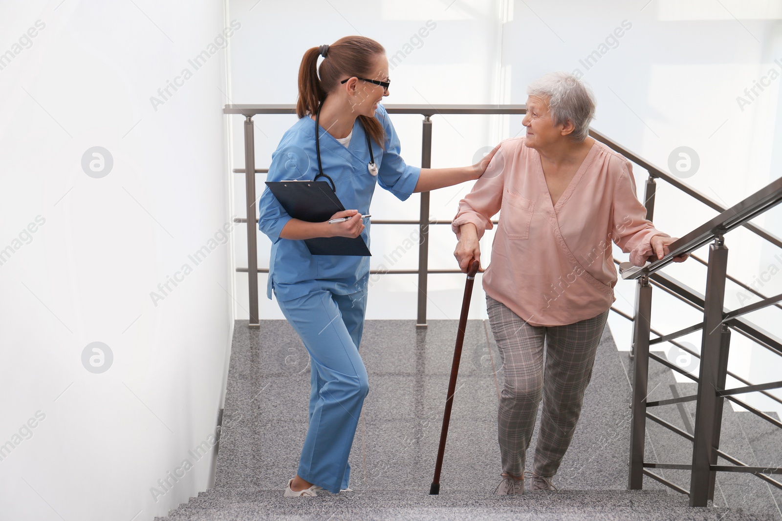 Photo of Doctor helping senior patient in modern hospital