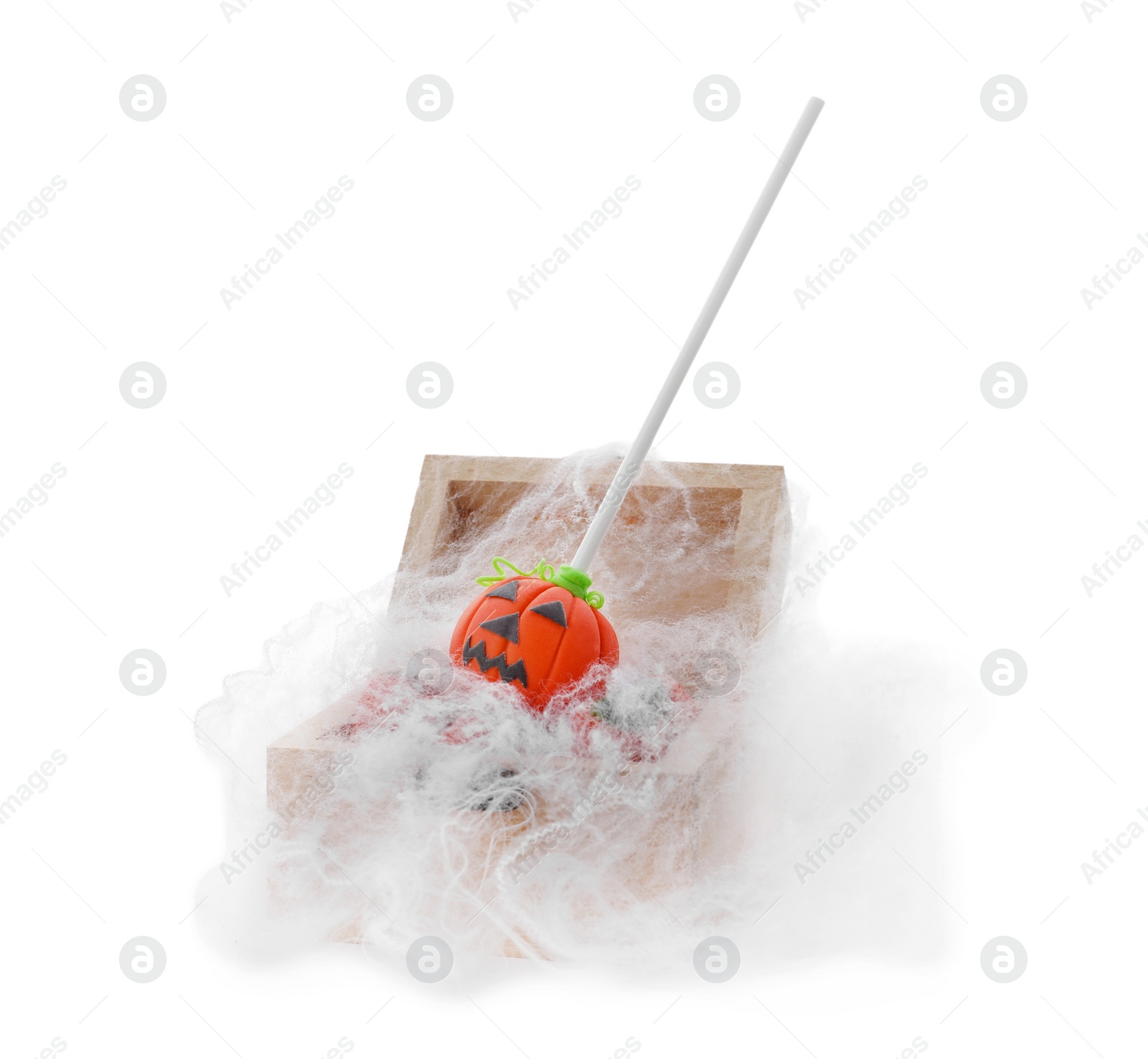 Photo of Delicious jack-o-lantern cake pop in small wooden chest with decorative cobweb on white background. Halloween season
