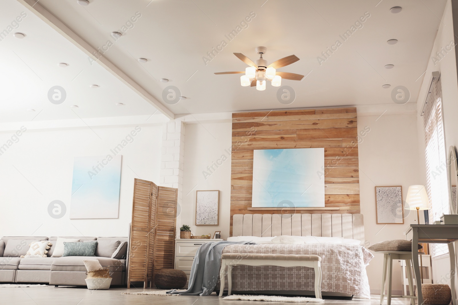 Photo of Stylish apartment interior with modern ceiling fan, low angle view