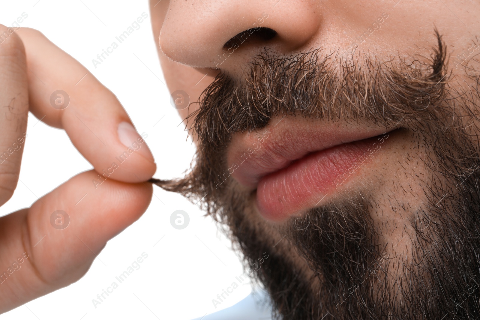 Photo of Young man touching mustache on white background, closeup