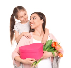 Portrait of happy woman with gifts and her daughter on white background. Mother's day celebration