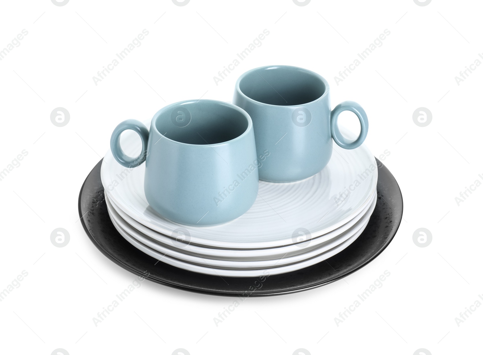 Photo of Beautiful ceramic plates and cups isolated on white