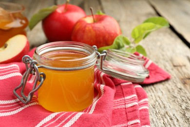 Photo of Sweet honey and fresh apples on wooden table, selective focus . Space for text