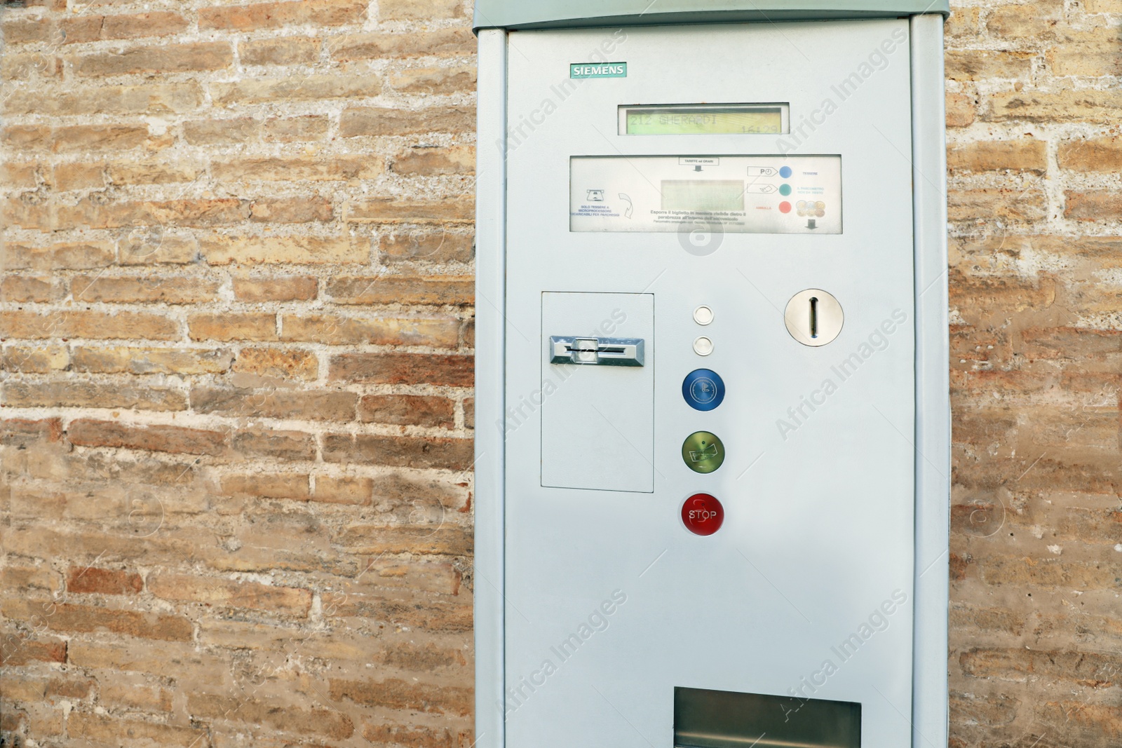 Photo of Senigallia, Italy - April 30, 2022: Parking meter on brick wall
