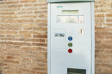 Senigallia, Italy - April 30, 2022: Parking meter on brick wall