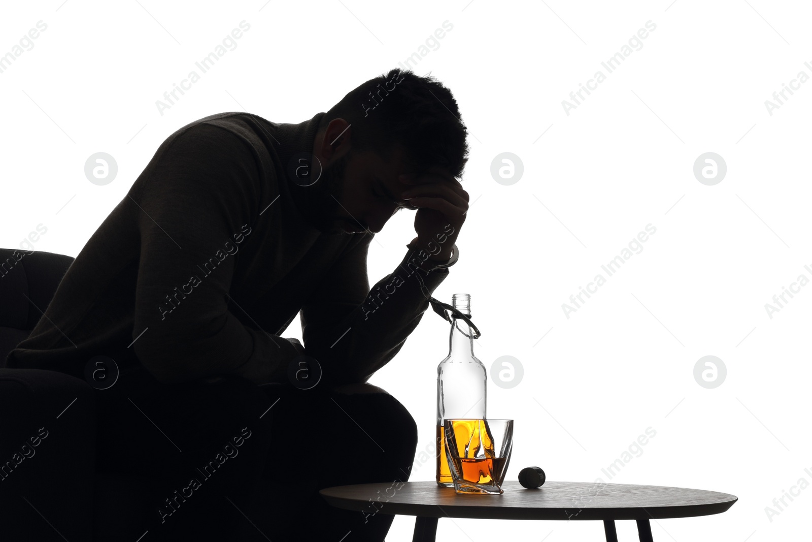 Photo of Silhouette of addicted man in handcuffs with alcohol bottle on white background