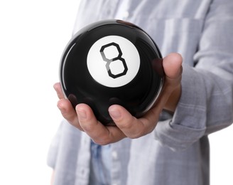 Photo of Woman holding magic eight ball on white background, closeup